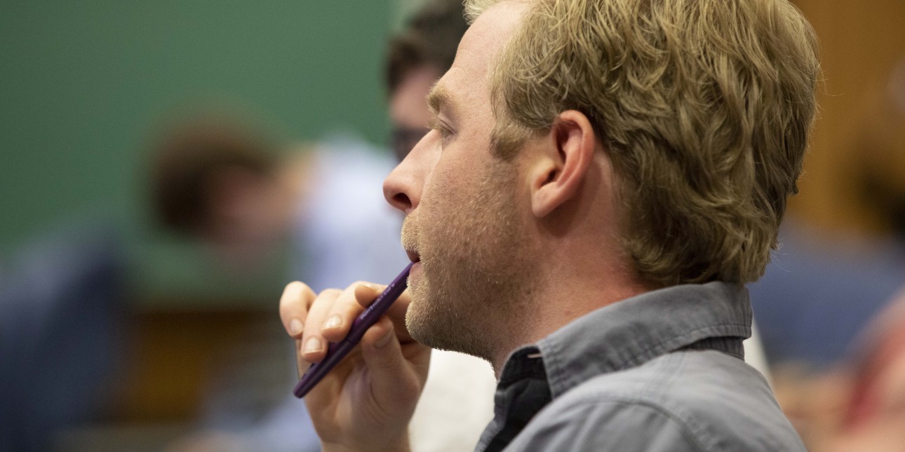 A journalist listening to a presentation at a One-Day Law School for Journalists™ at the University of Pittsburgh School of Law