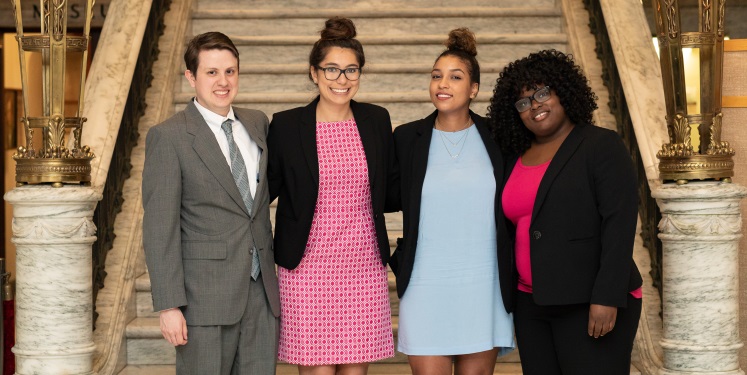 Four people standing in front of a staircase at PMC's Judicial Independence Benefit