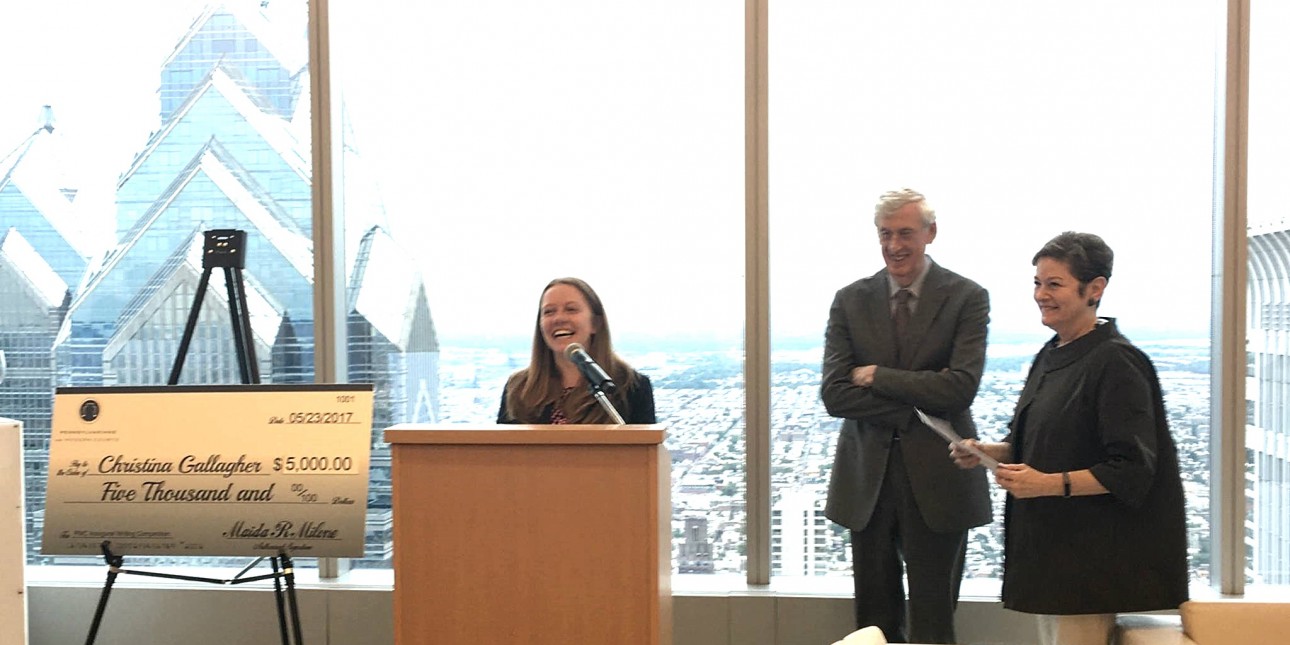Christina Gallagher, winner of PMC's 2017 Law Student Writing Competition, standing at a podium with Robert Heim, PMC's Chair, and Maida Milone, PMC's Presidnet & CEO