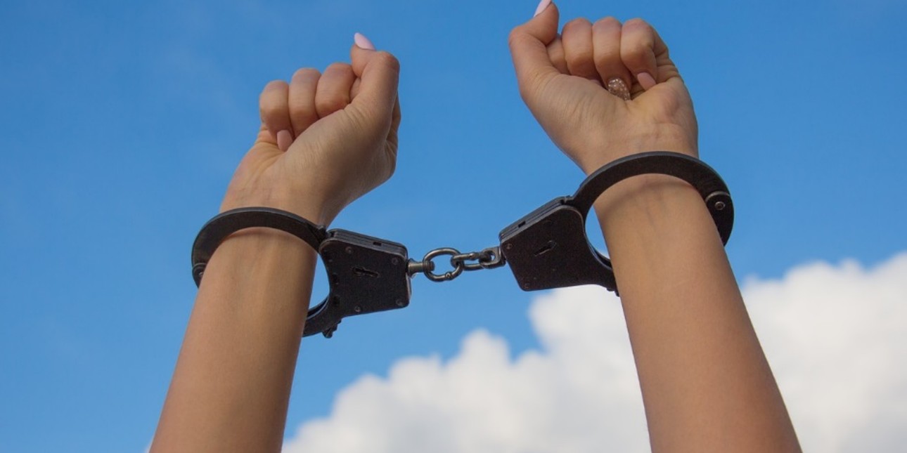 Two hands in handcuffs