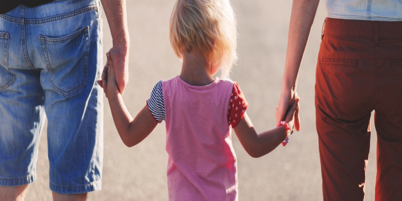 Child holding parents' hands