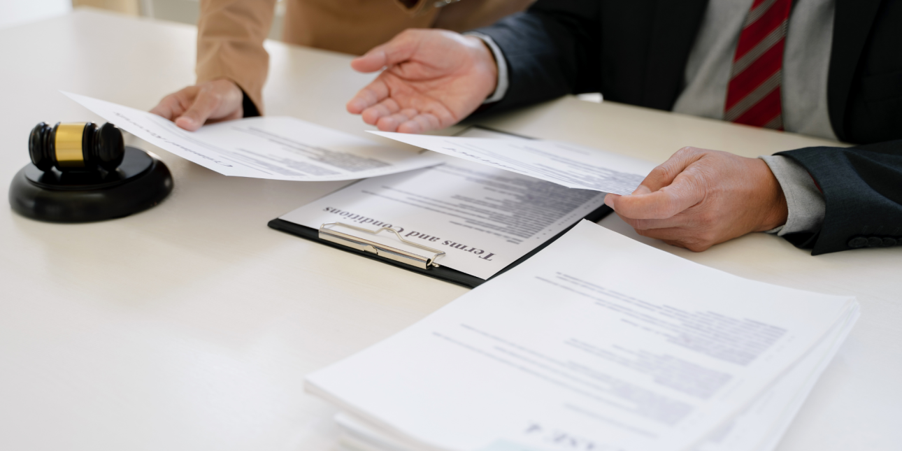 Two people reviewing legal documents 