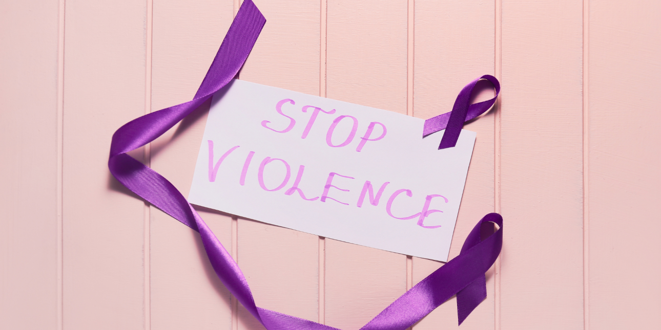 purple domestic violence awareness ribbon with a sign that says "Stop Violence"