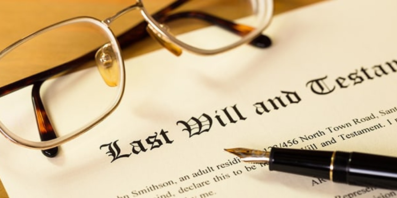 Image of a last will and testament document with pen and glasses placed on top of the document