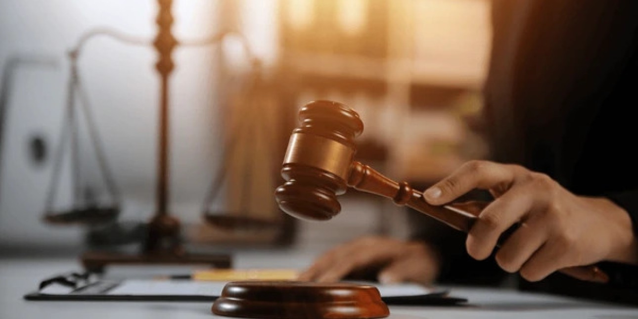 An image of a hand holding a gavel