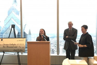 Christina Gallagher, winner of PMC's 2017 Law Student Writing Competition, standing at a podium with Robert Heim, PMC's Chair, and Maida Milone, PMC's Presidnet & CEO